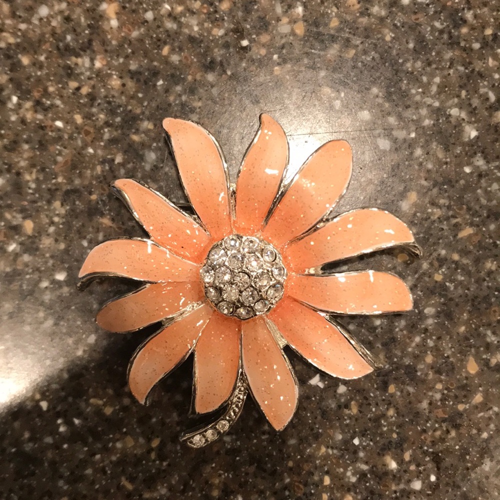 Pink enamel and rhinestone flower brooch.